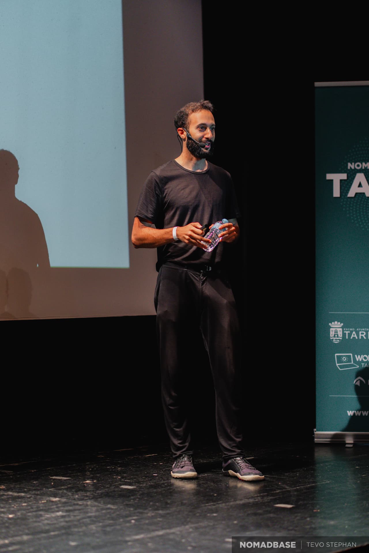 César speaking on stage